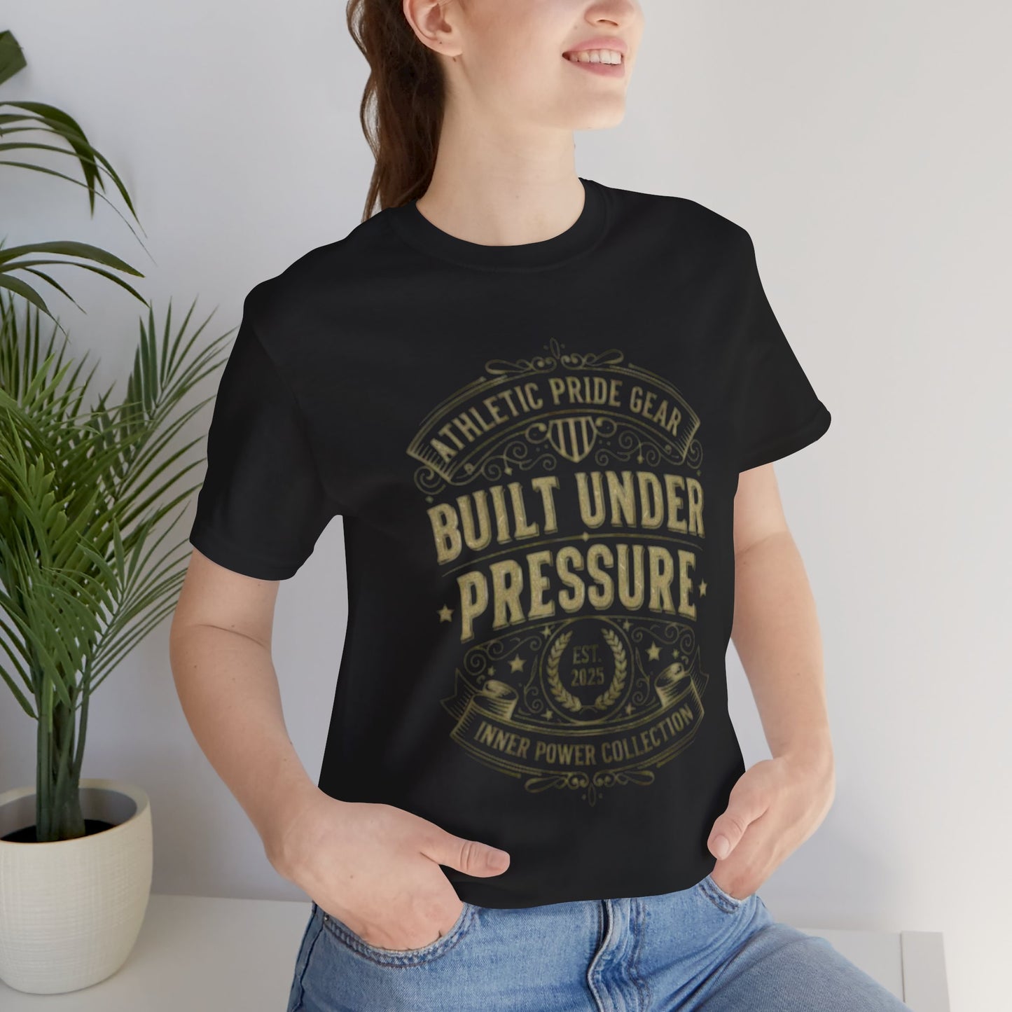 Person wearing a black t-shirt with a graphic design and text, standing indoors.