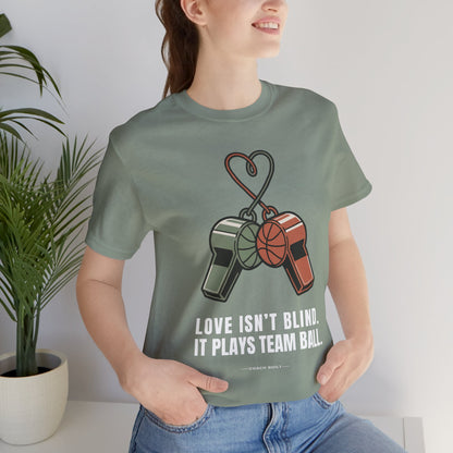 Love Isn’t Blind (white text) — It Plays Team Ball Tee