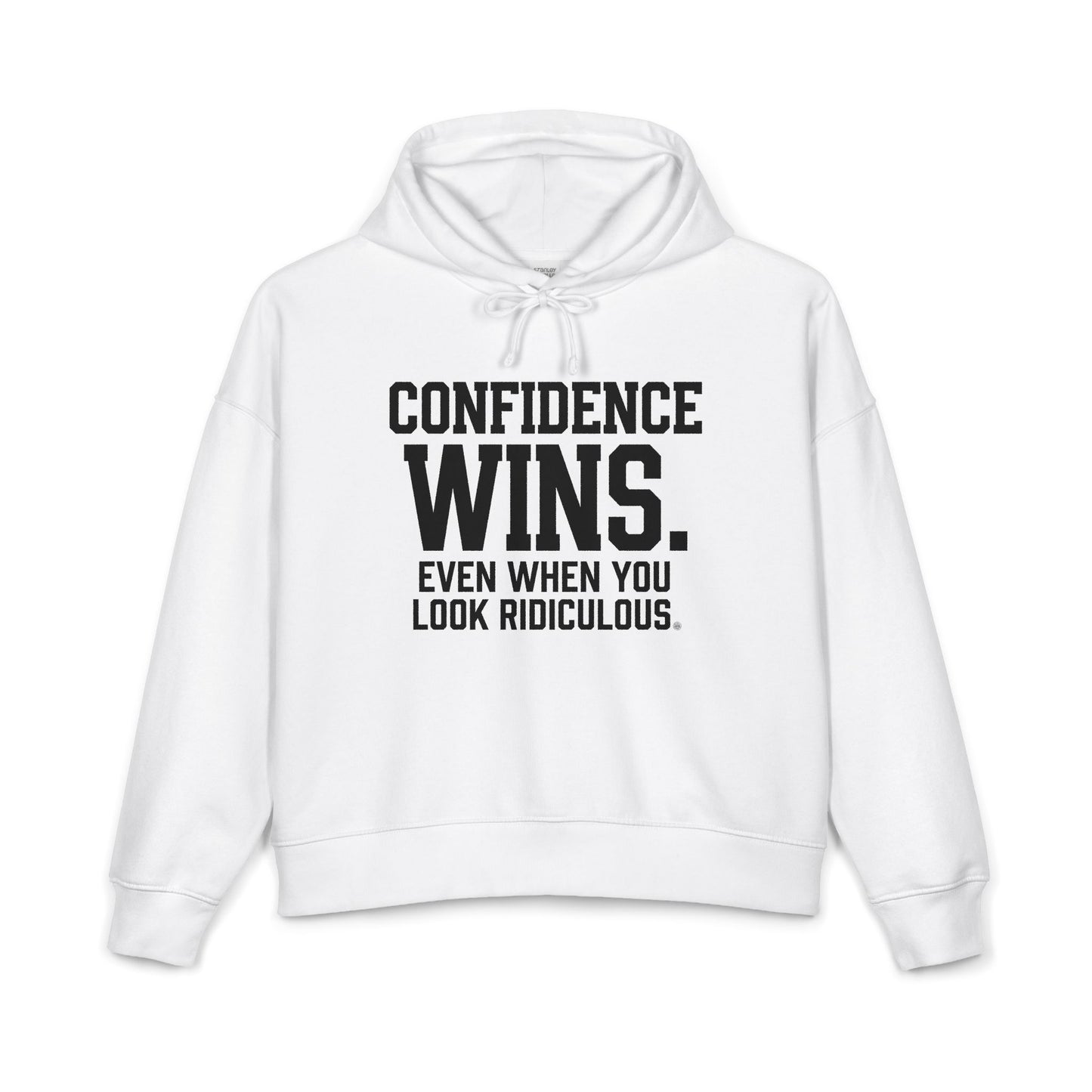 A white cropped hoodie with black text on the front reading 'CONFIDENCE WINS. EVEN WHEN YOU LOOK RIDICULOUS.
