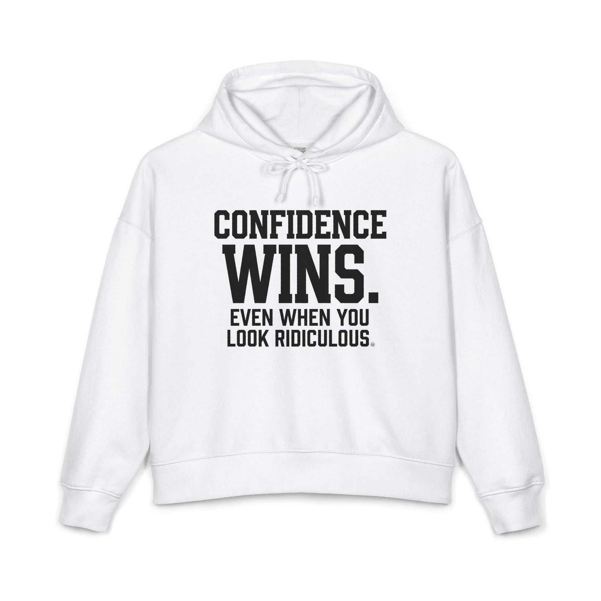 A white cropped hoodie with black text on the front reading 'CONFIDENCE WINS. EVEN WHEN YOU LOOK RIDICULOUS.
