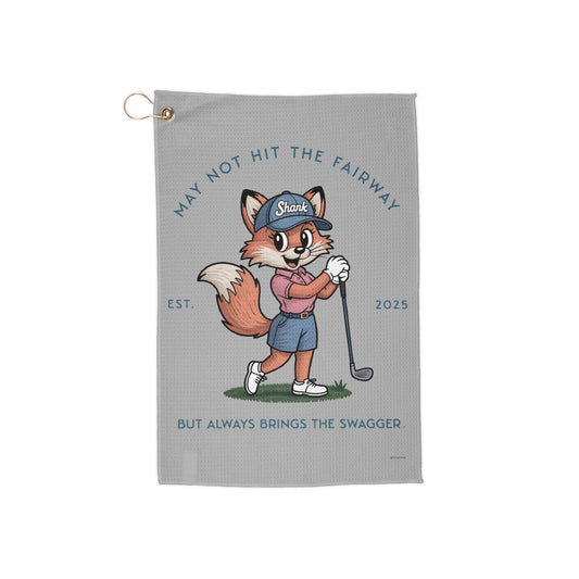 Golf towel with a cartoon fox character holding a golf club on a gray background